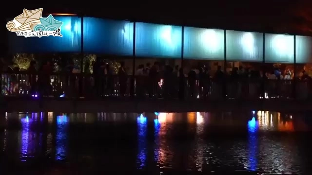 夜晚水岸邊透光玻璃裝置藝術,五彩水燈漂浮在水面上並倒映燈光