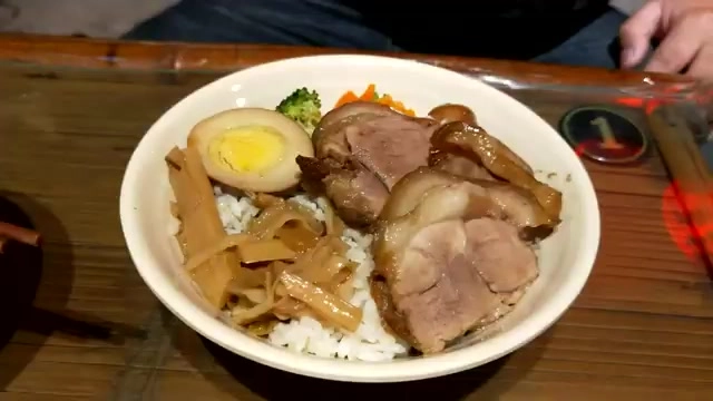 另一角度的封肉飯特寫，可見滷蛋、筍絲與軟嫩封肉