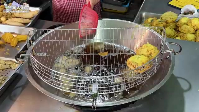 炸物在滾油裡翻騰,麵衣裹著新鮮魩仔魚炸得金黃酥脆