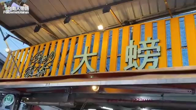 黃色格柵招牌上寫著「大螃蟹」字樣，配有螃蟹圖案裝飾