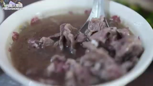 牛肉湯特寫，湯匙舀起鮮嫩牛肉片，湯色清澈帶著淡淡油花