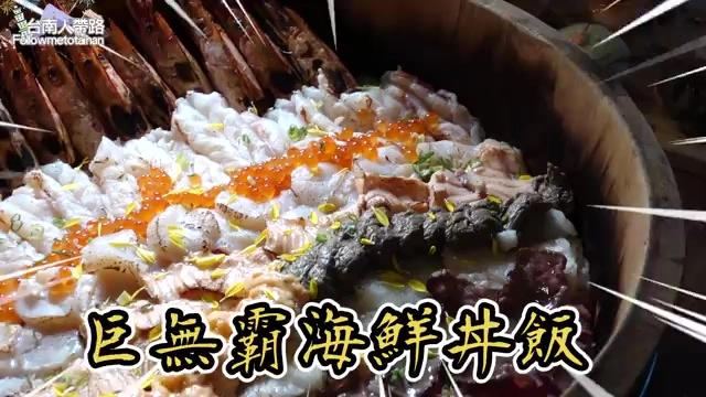 巨無霸海鮮丼飯特寫，鋪滿鮭魚卵、甜蝦、比目魚等豐富海鮮配料，插滿裝飾竹籤，標示「巨無霸海鮮丼飯」