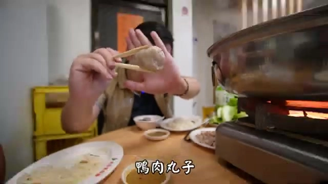 筷子夾起鴨肉丸子沾上辣醬，軟嫩多汁的口感是新竹當地的特色做法