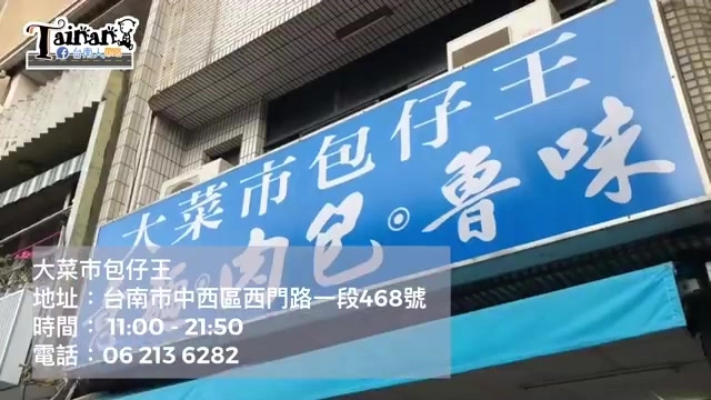 店面招牌，藍底白字寫著「大菜市包仔王」，標示「肉包」「魯味」字樣，下方顯示地址與電話資訊