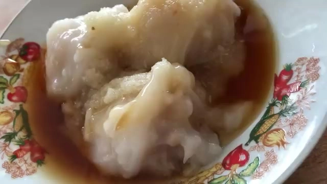 白色花紋瓷盤盛著肉圓，外皮軟嫩透亮，淋上醬色醬汁